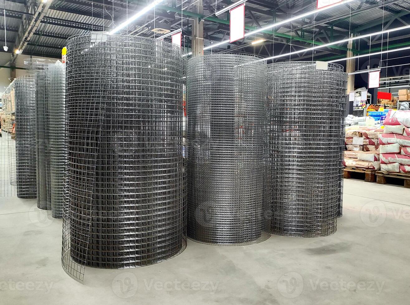 Sale of welded galvanized mesh in rolls in a building materials store inside, background photo