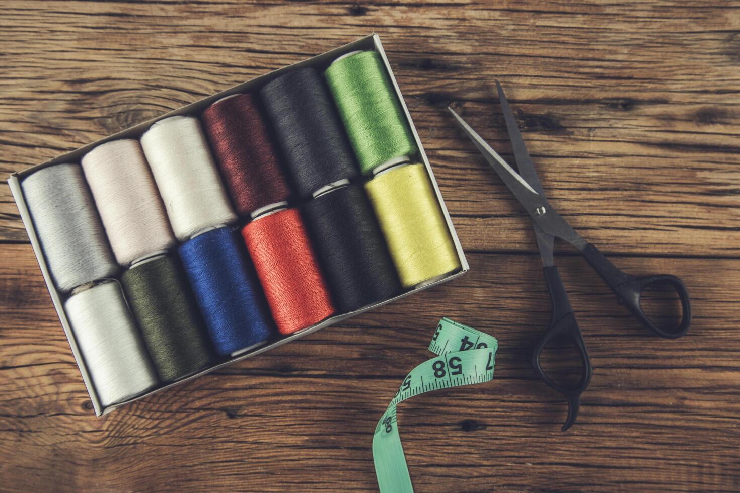 A box of spools of thread and scissors photo
