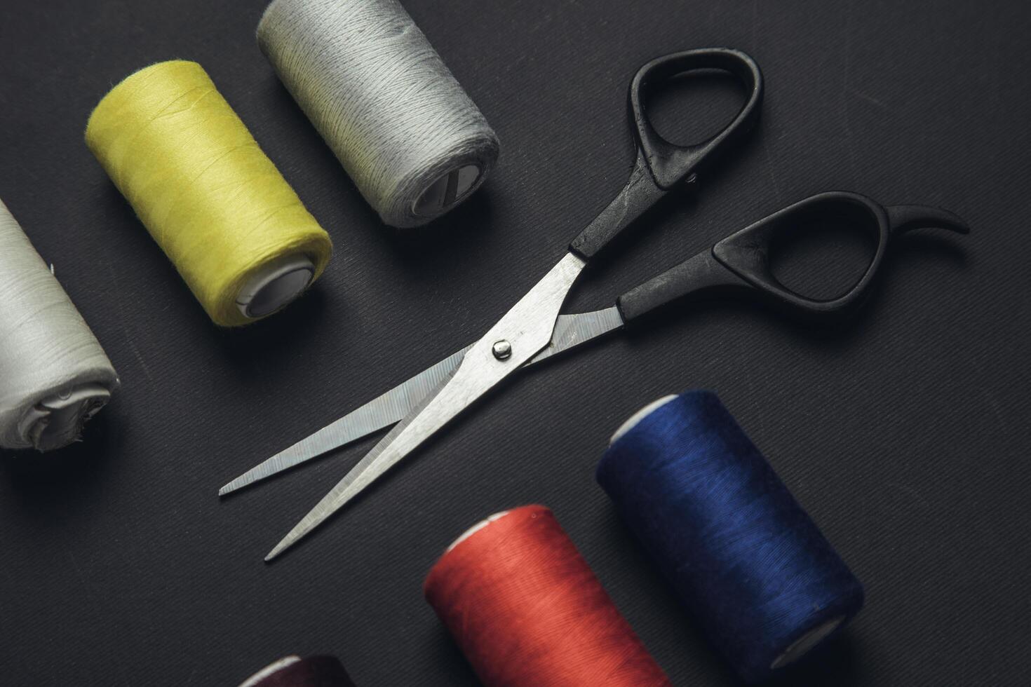 Colorful sewing threads and scissors photo