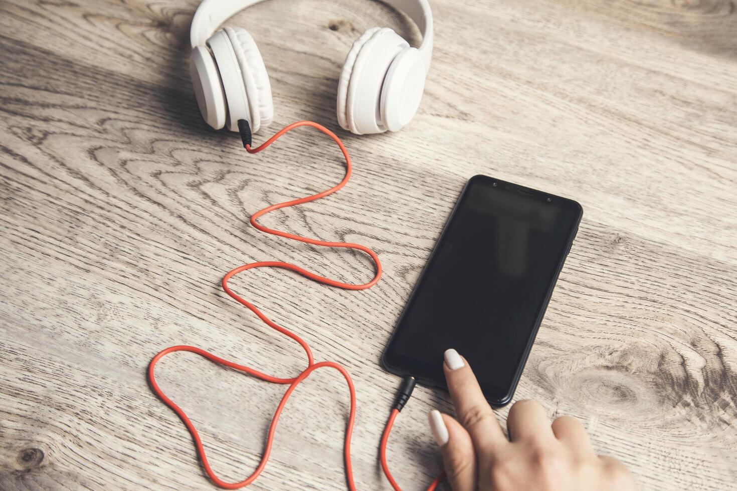 woman holding phone and earphone photo