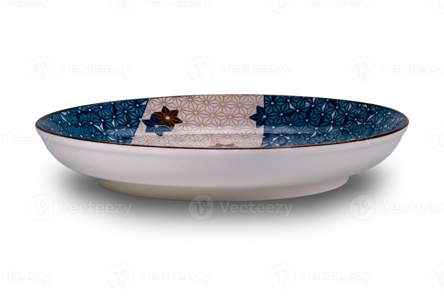 Side view of empty blue and brown star pattern dark edge ceramic plate isolated on white background. photo