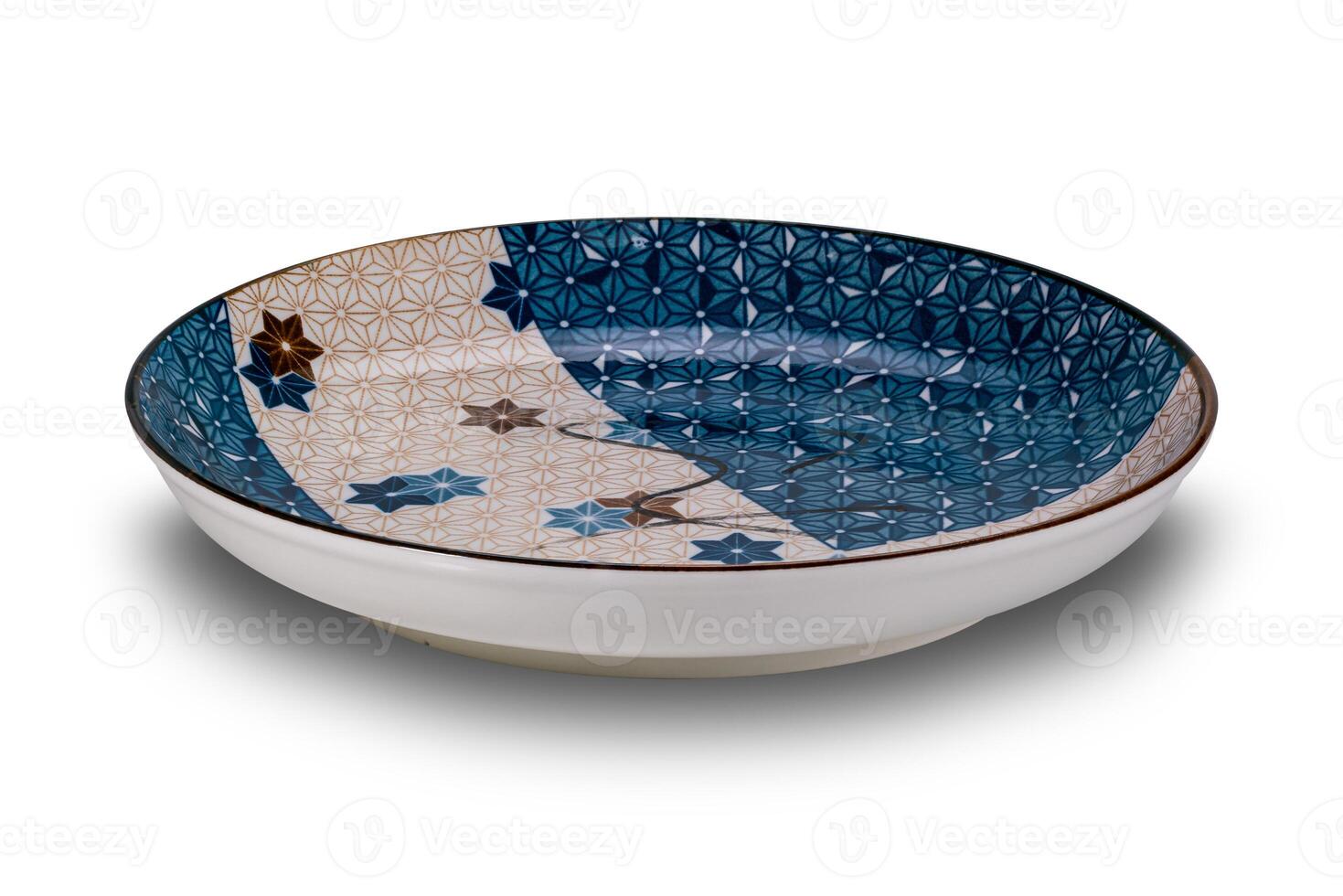 High angle view of empty blue and brown star pattern dark edge ceramic plate isolated on white background. photo