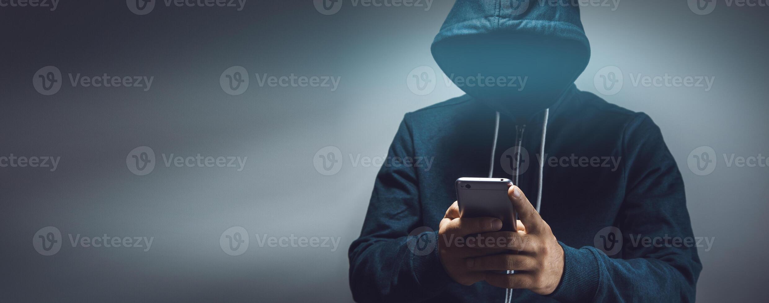 the hacker holding smart phone photo