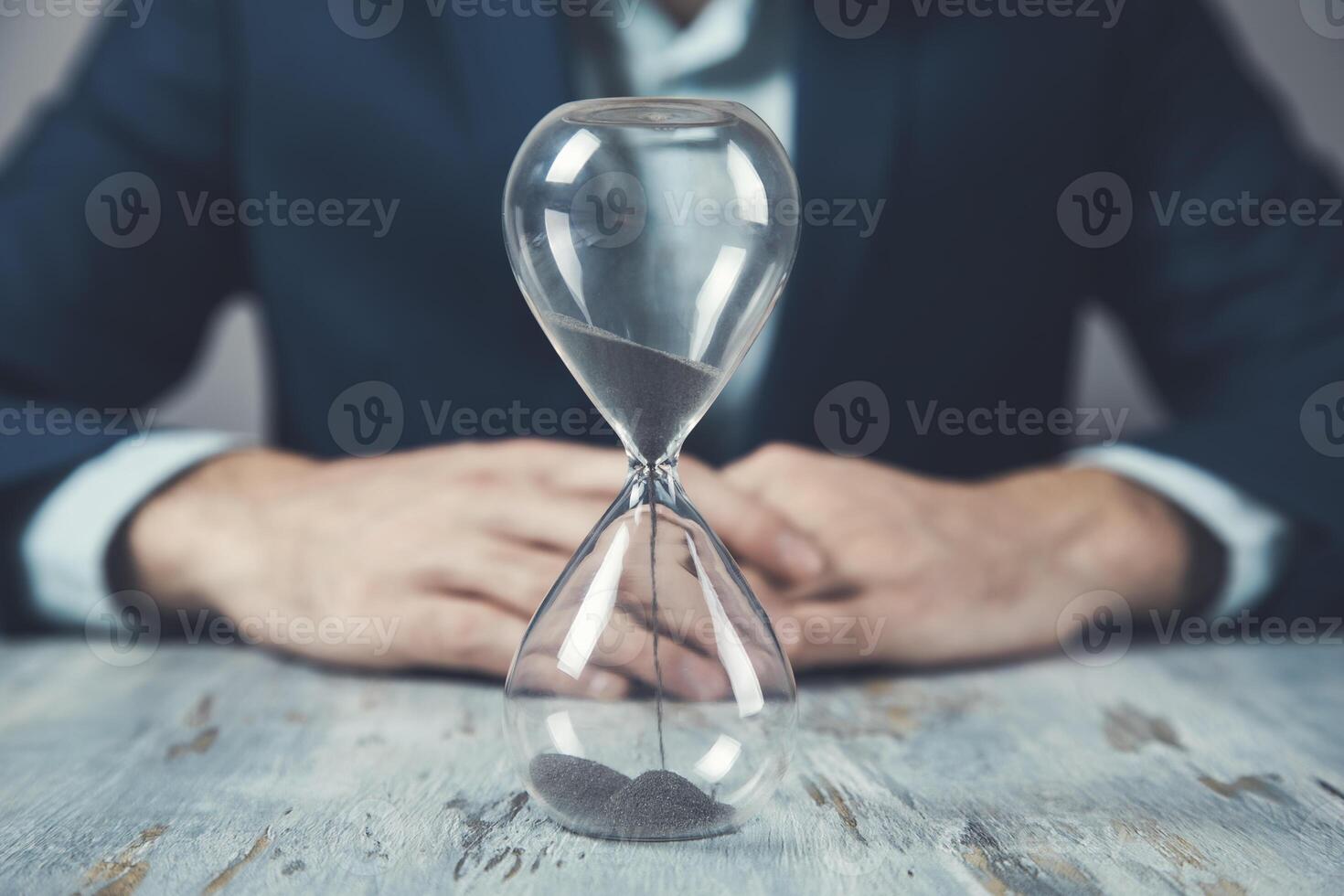young business man with hourglass photo
