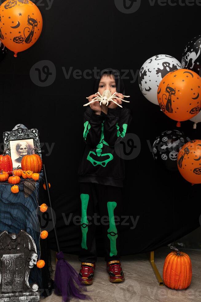 Halloween. A boy in a skeleton costume. Celebrating Halloween photo