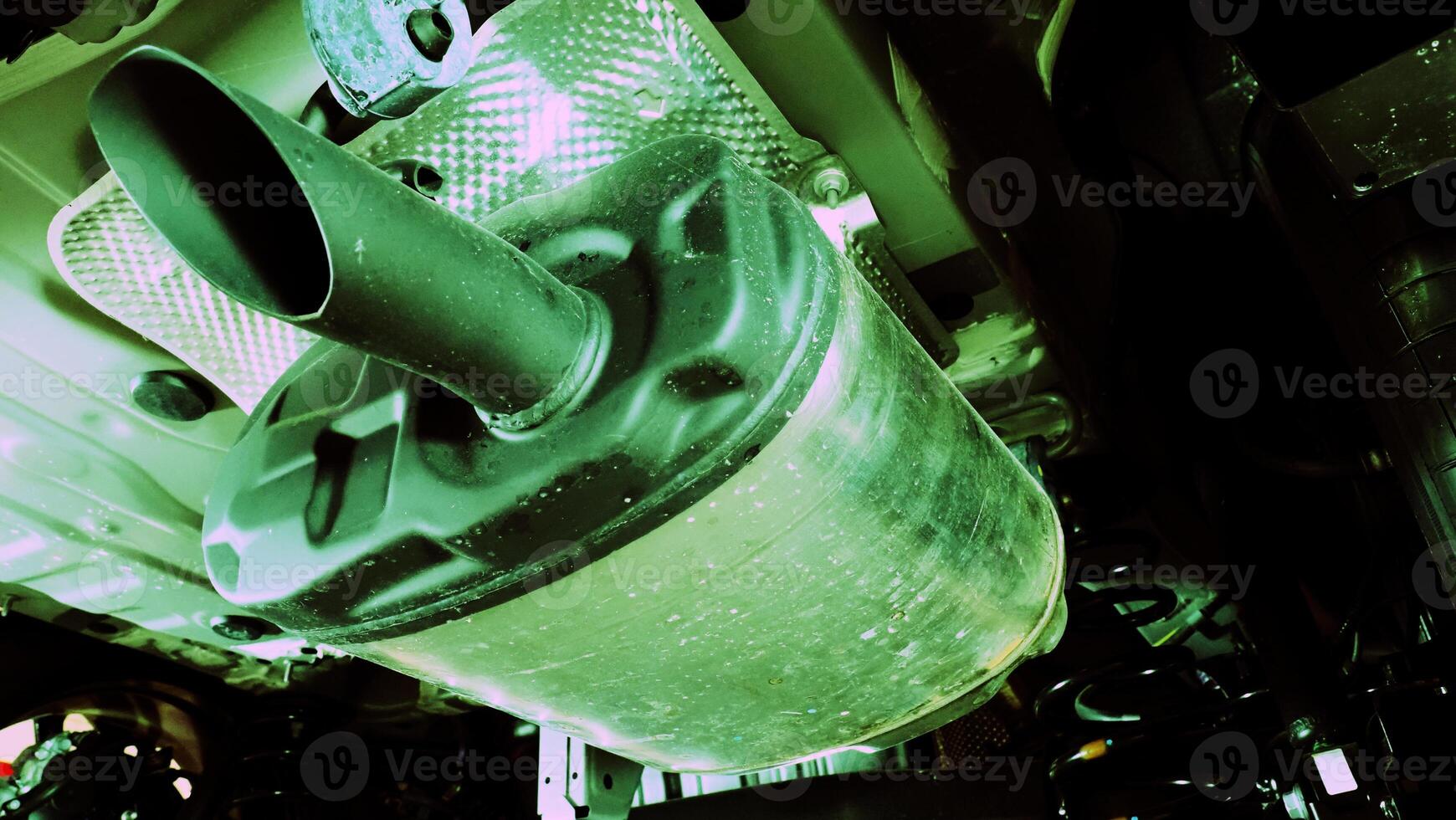 Under car exhaust pipes and suspension. Automotive mufflers. Inspection of car for Defects. Metal fittings and pipes for the muffler. Suspension elements and exhaust system. Auto parts and car service photo