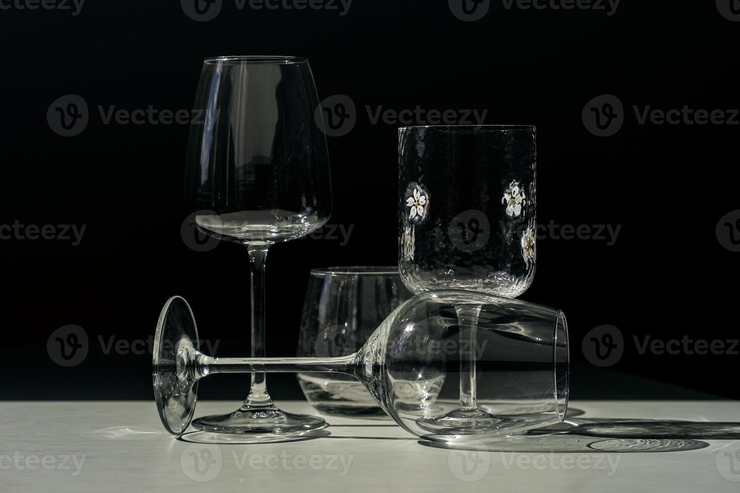 Assorted glassware for various drinks in sunlight. photo
