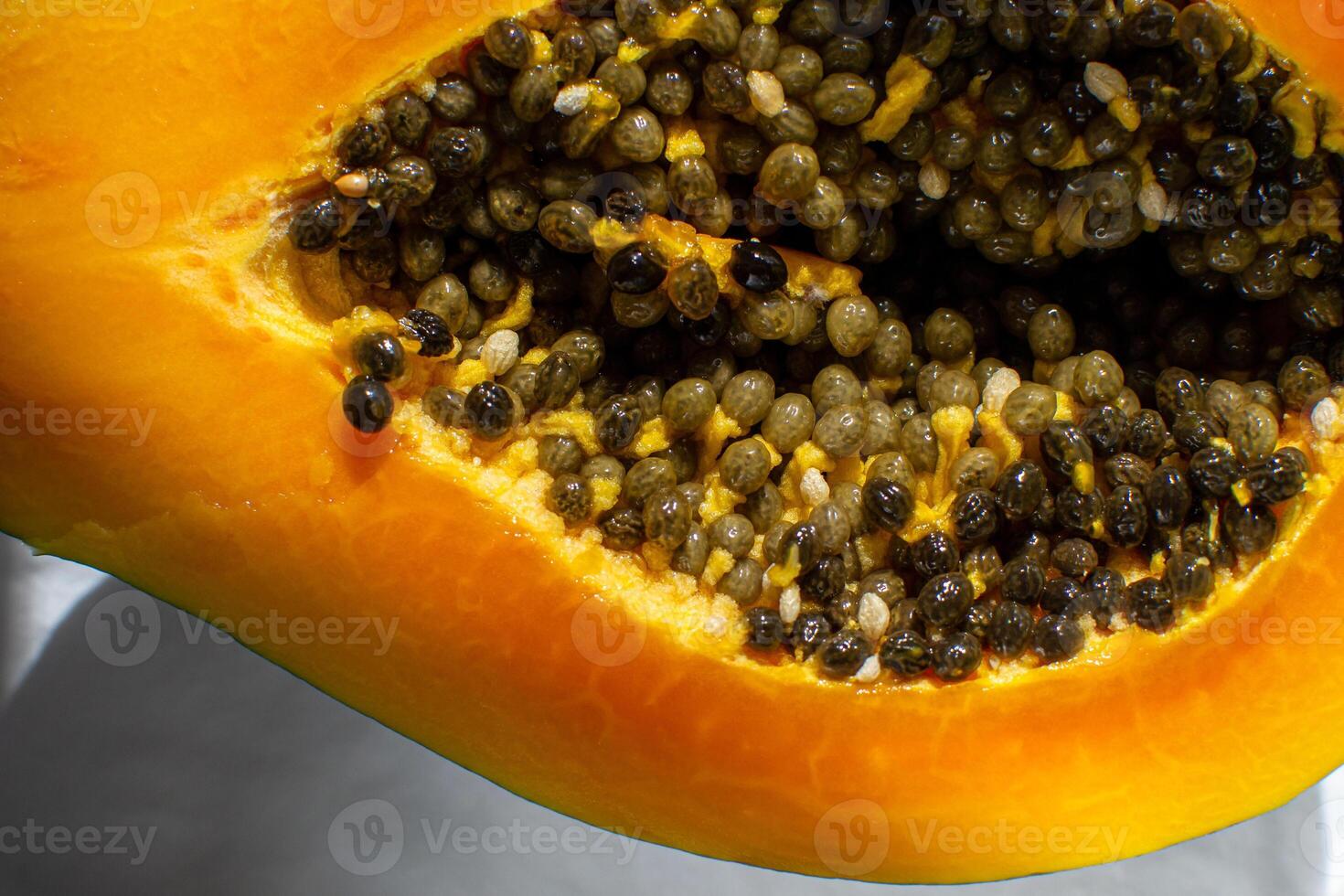 Top view of papaya fruit cut in half with grains. photo
