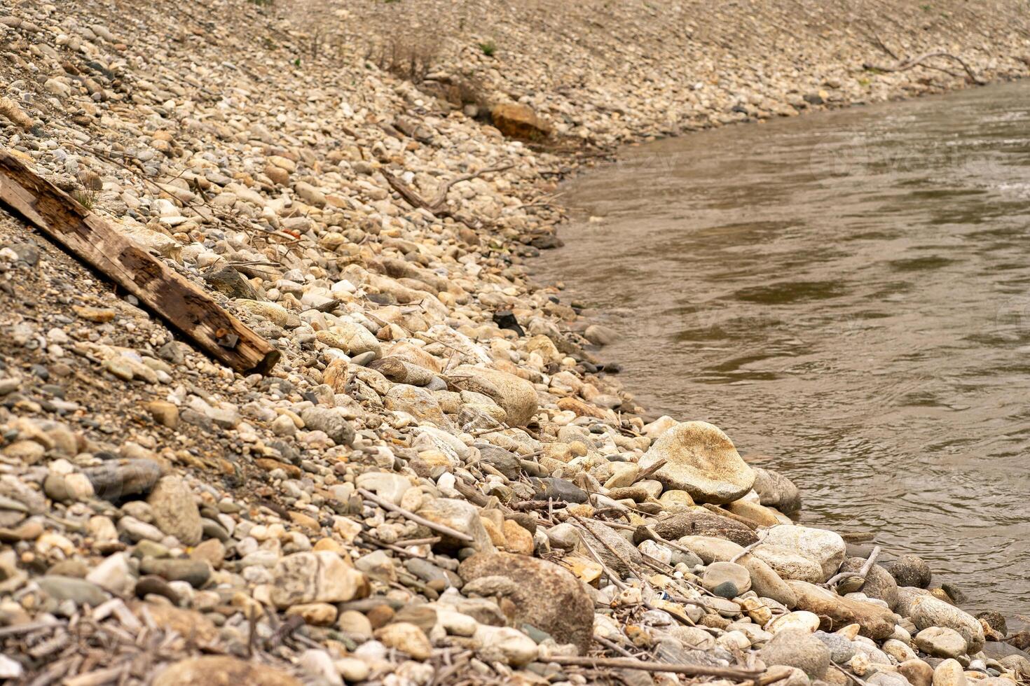 View of the stone bank of a mountain river in early spring photo
