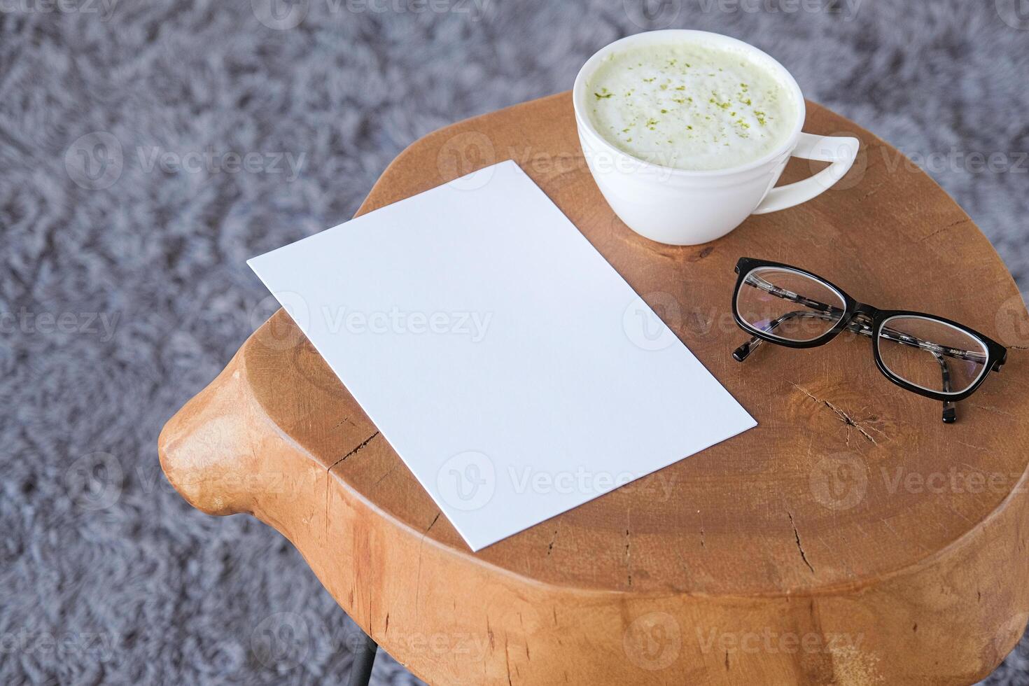 blank paper sheet mockup on wood coffee table with green matcha tea photo