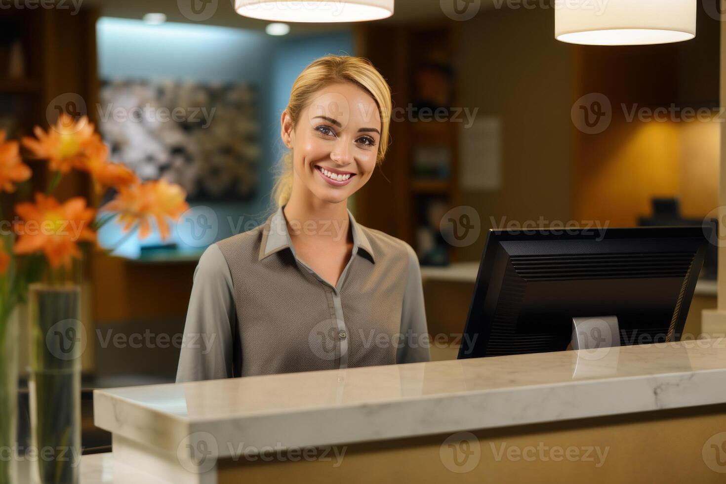 Smiling female receptionist working at hotel reception desk photo