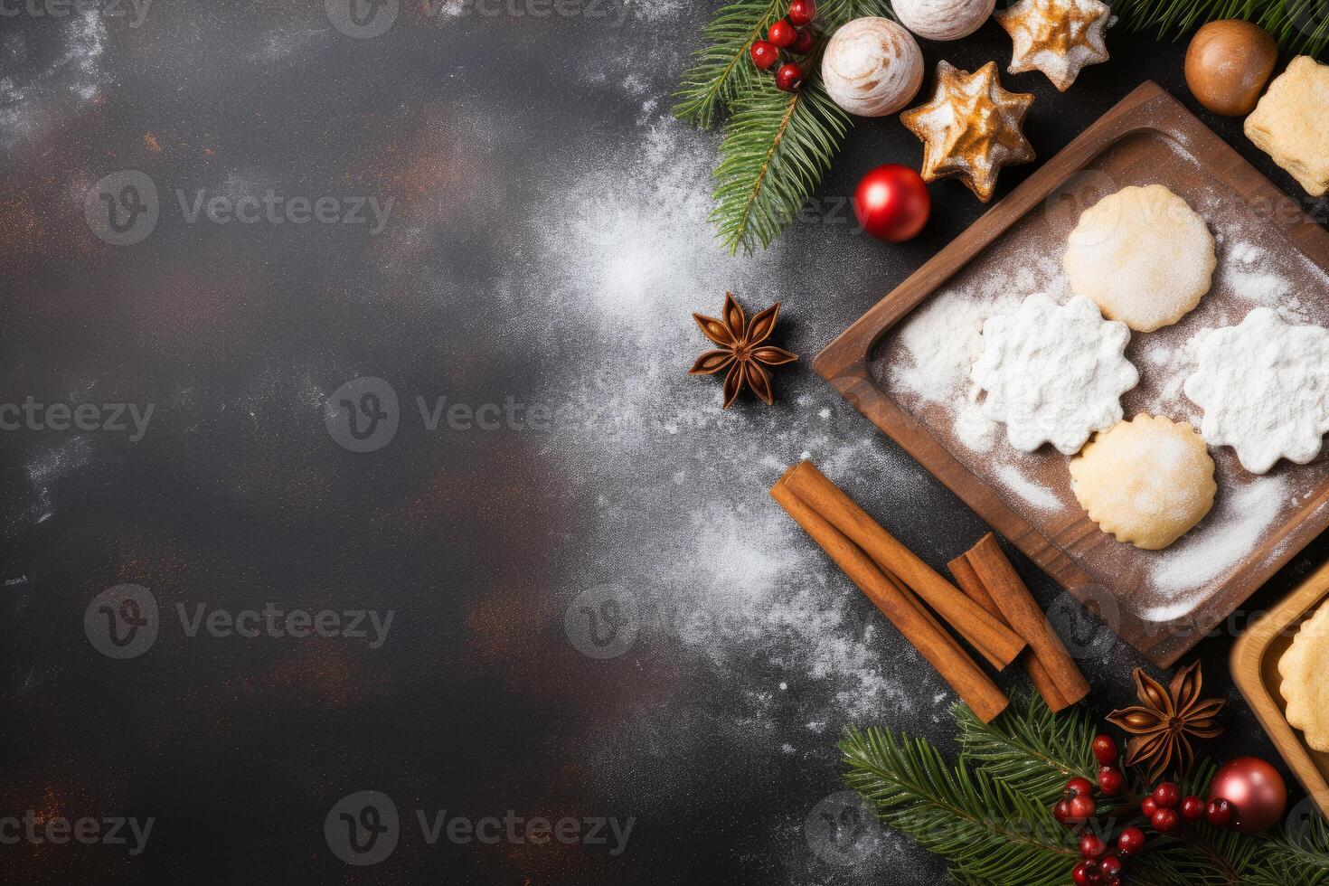 Christmas baking background showing cookies, cinnamon sticks, berries, and star anise on dark rustic table photo
