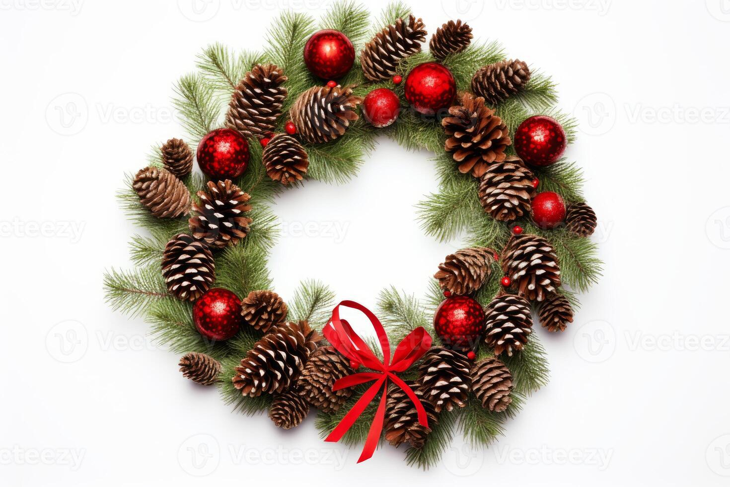 Christmas wreath decorated with pine cones, red balls, and ribbon on white background photo