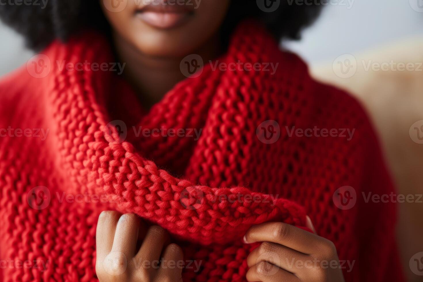 Woman warming up with a red knitted scarf photo
