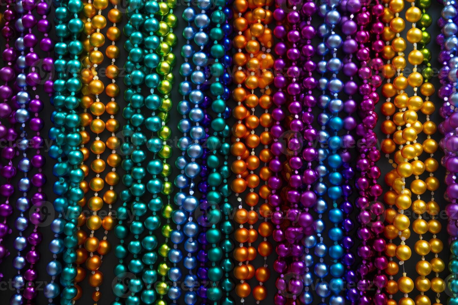 Colorful mardi gras beads hanging in vertical rows creating vibrant pattern photo