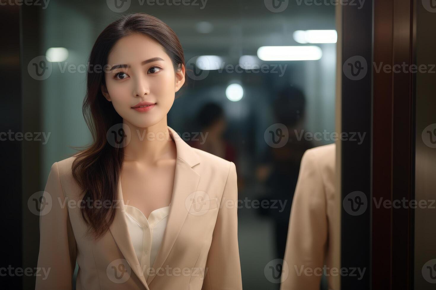 Young asian businesswoman smiling confidently in office corridor photo