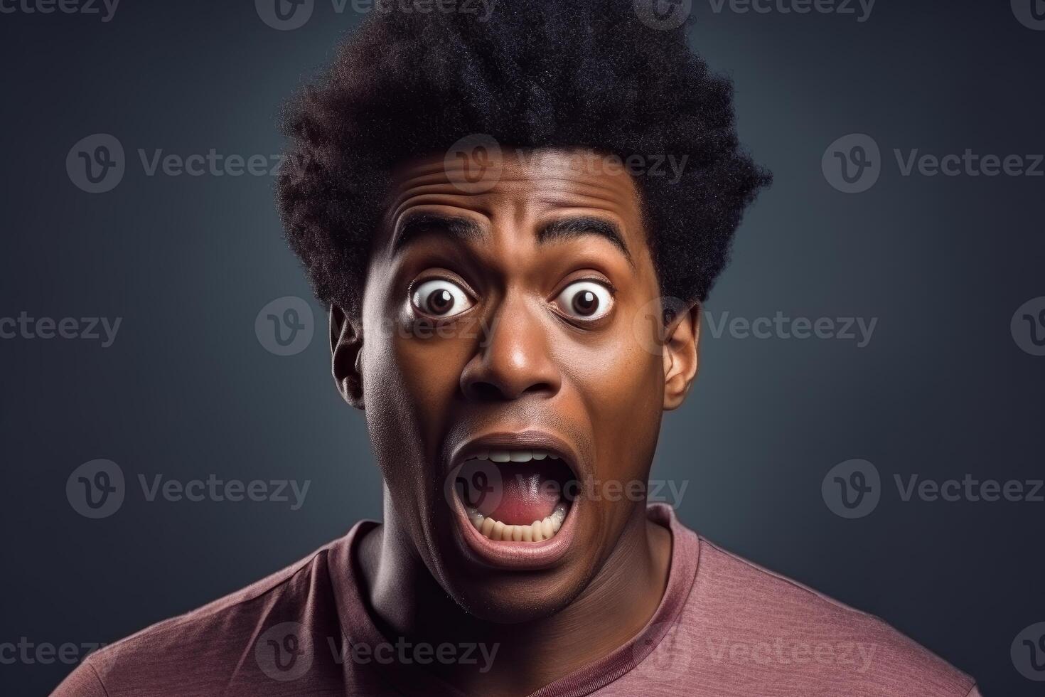 Shocked young man showing fear and surprise expression with wide open eyes and mouth photo