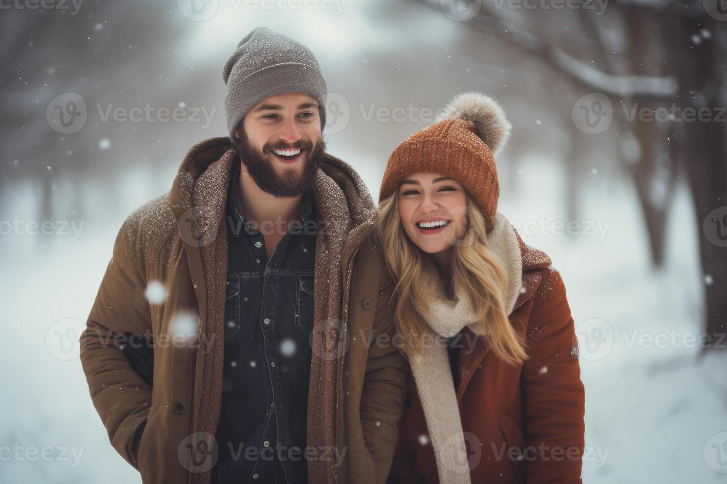 Happy couple walking in snowy woods enjoying winter day photo