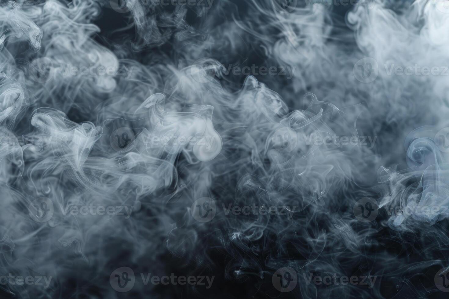 White smoke creating abstract shapes on dark background photo
