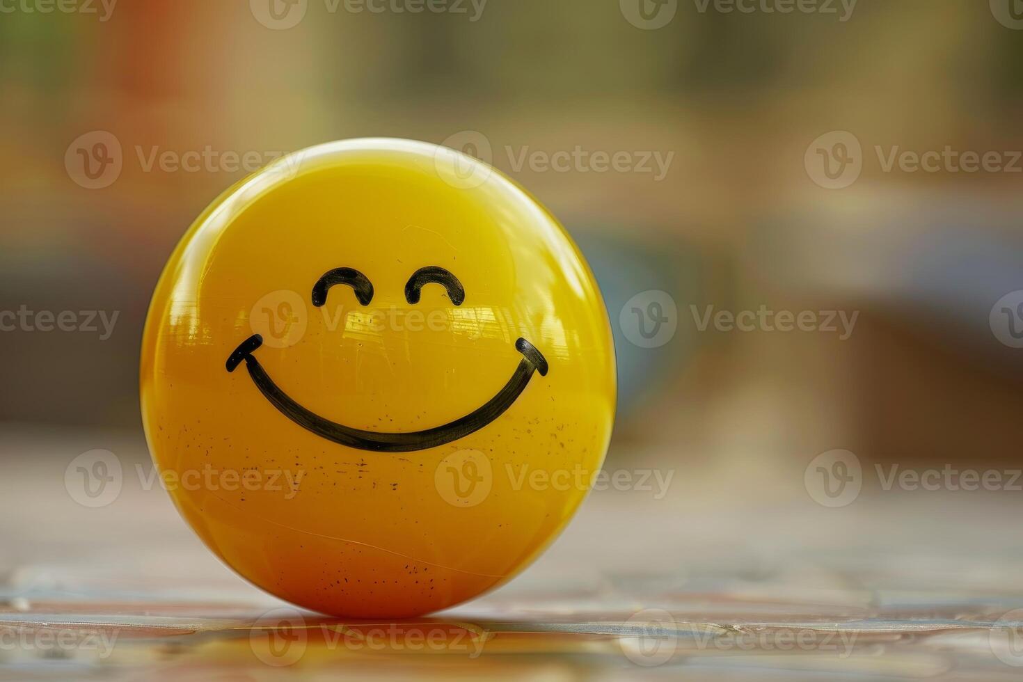 Yellow sphere expressing happiness with a drawn smile photo