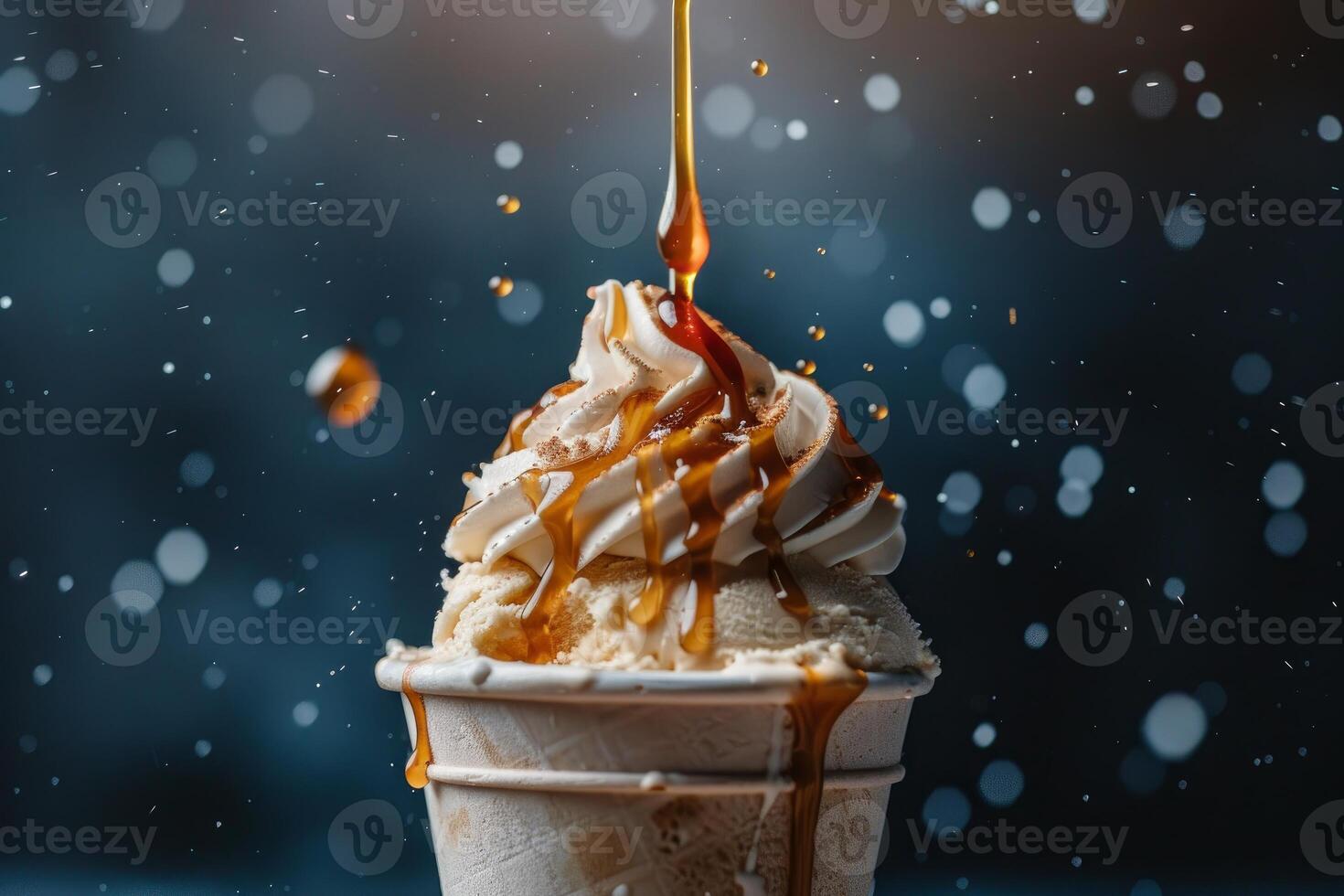 Delicious ice cream dessert with whipped cream and caramel sauce drizzling down photo