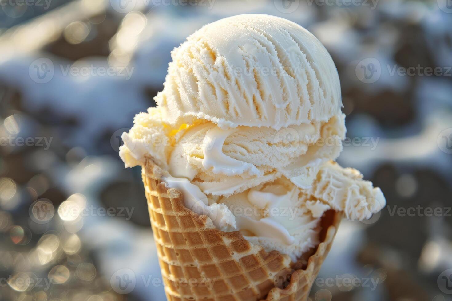 Delicious vanilla ice cream melting in waffle cone on sunny day photo