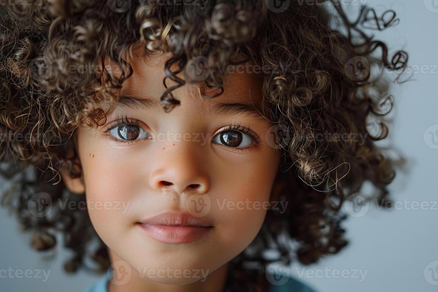 Portrait of adorable young child with curly hair showing confidence and innocence photo