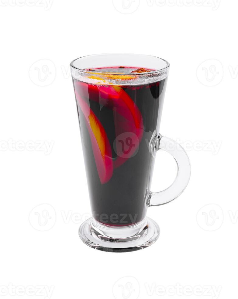 Delicious warm beverage with spices and fruits served in a clear glass during a chilly evening photo