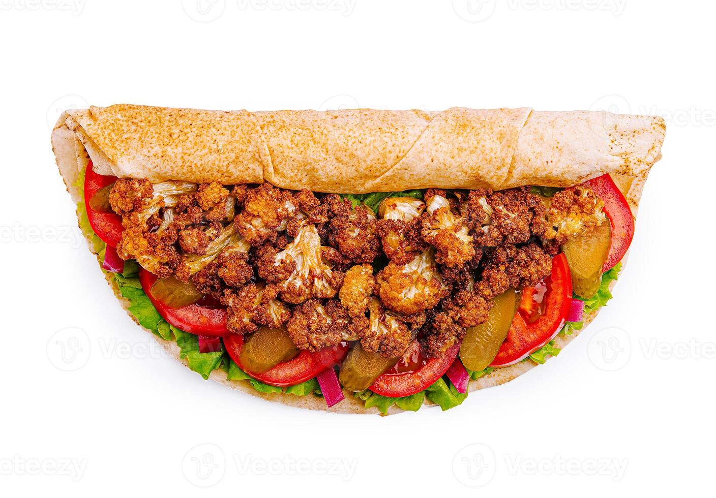 Delicious wrap filled with crispy cauliflower, fresh vegetables, and savory sauce in a whole grain tortilla photo