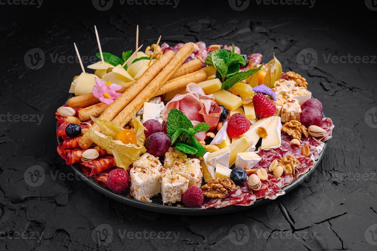 Exquisite charcuterie platter featuring a variety of cheeses, meats, fruits, and nuts displayed elegantly for a festive gathering photo