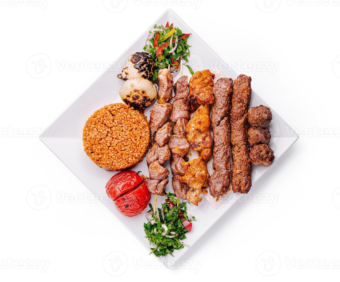 Grilled meat platter with rice and vegetables on a white plate celebrating traditional cuisine photo