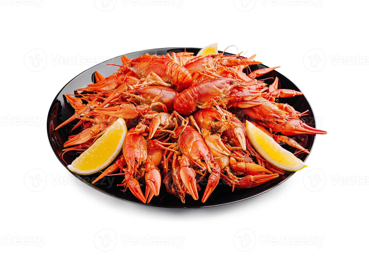 Deliciously prepared crayfish served on a black platter with lemon wedges at a seafood feast photo