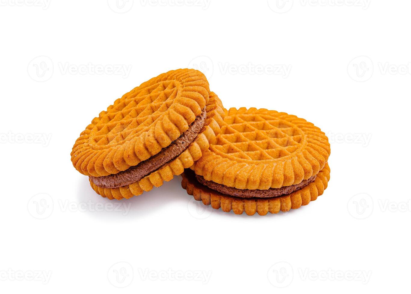 Cookies stacked on a white surface with a textured design and chocolate filling visible between them photo