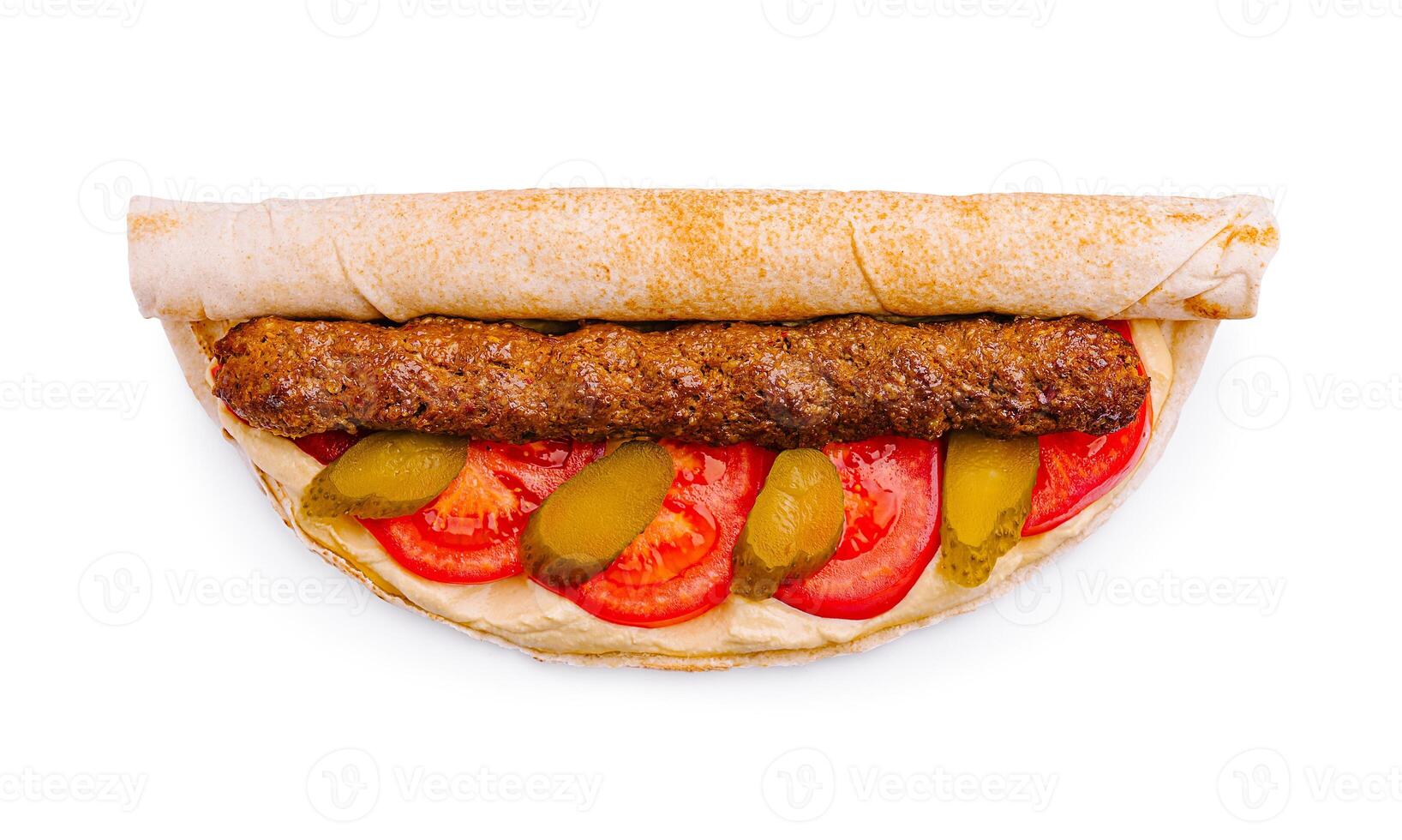 Delicious wrap filled with grilled meat, fresh vegetables, and creamy sauce served on a white background photo