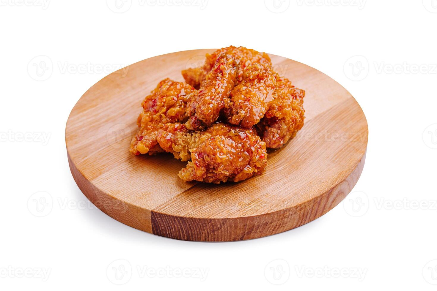 Crispy fried chicken pieces served on a wooden platter perfect for sharing during any meal or gathering photo