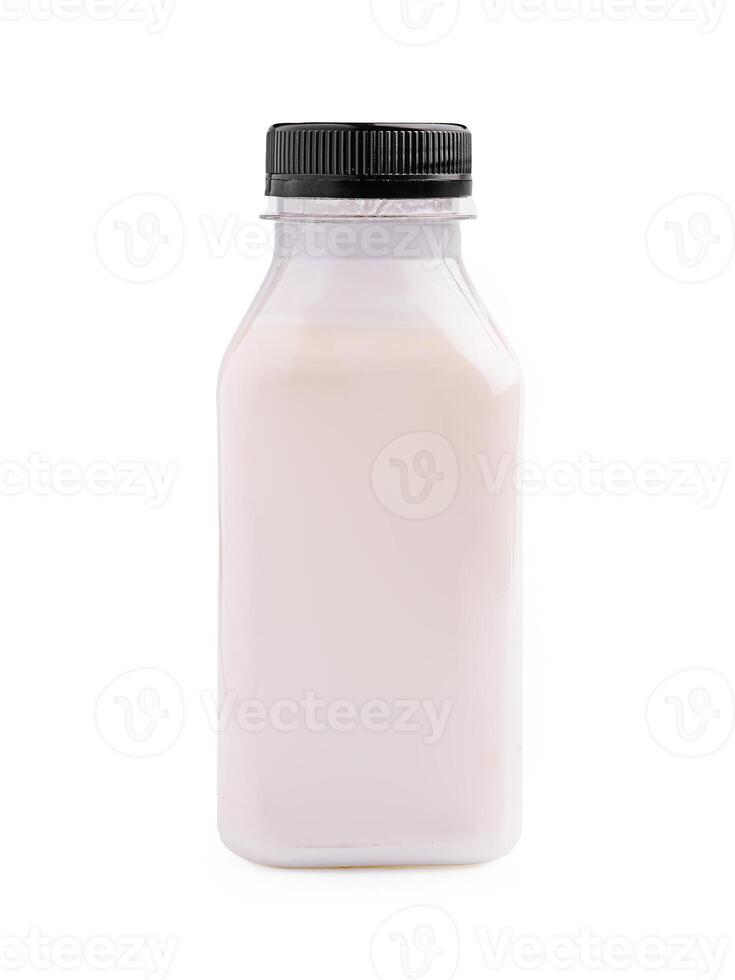 Bottle filled with creamy milk displayed against a plain background showcasing fresh dairy product photo