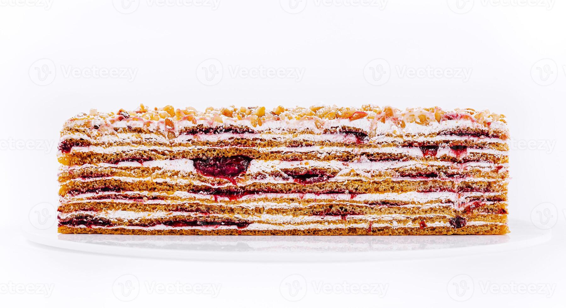 Delicious layered cake with cream and berry filling displayed on a clean surface photo