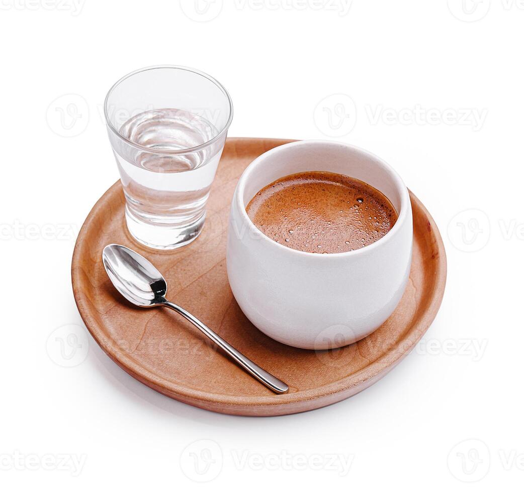 Hot beverage served with a glass of water on a wooden tray in a cozy setting photo