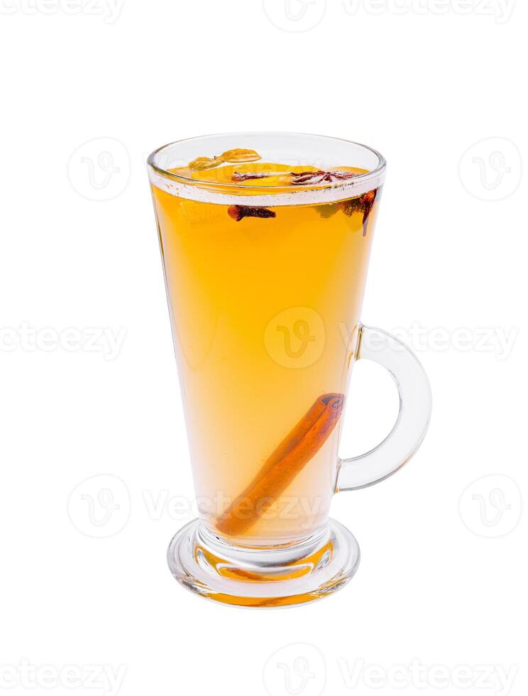 Warm spiced drink with cinnamon and cloves served in a clear glass cup on a white background at a cozy cafe photo
