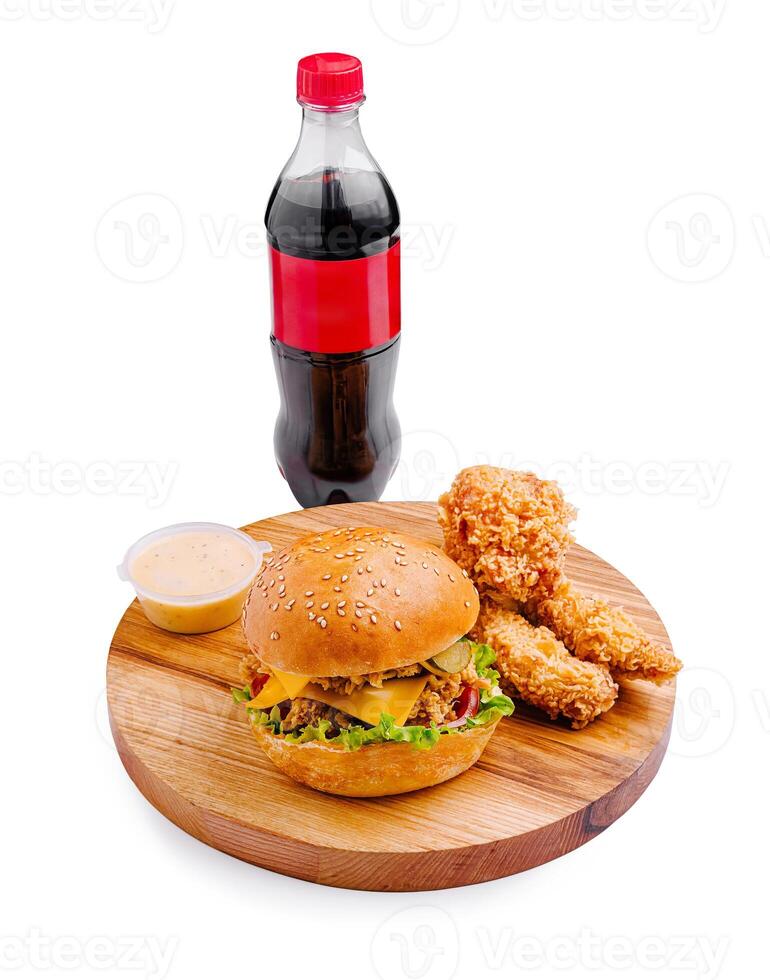 Delicious burger meal with crispy chicken strips and refreshing soda on a wooden platter photo