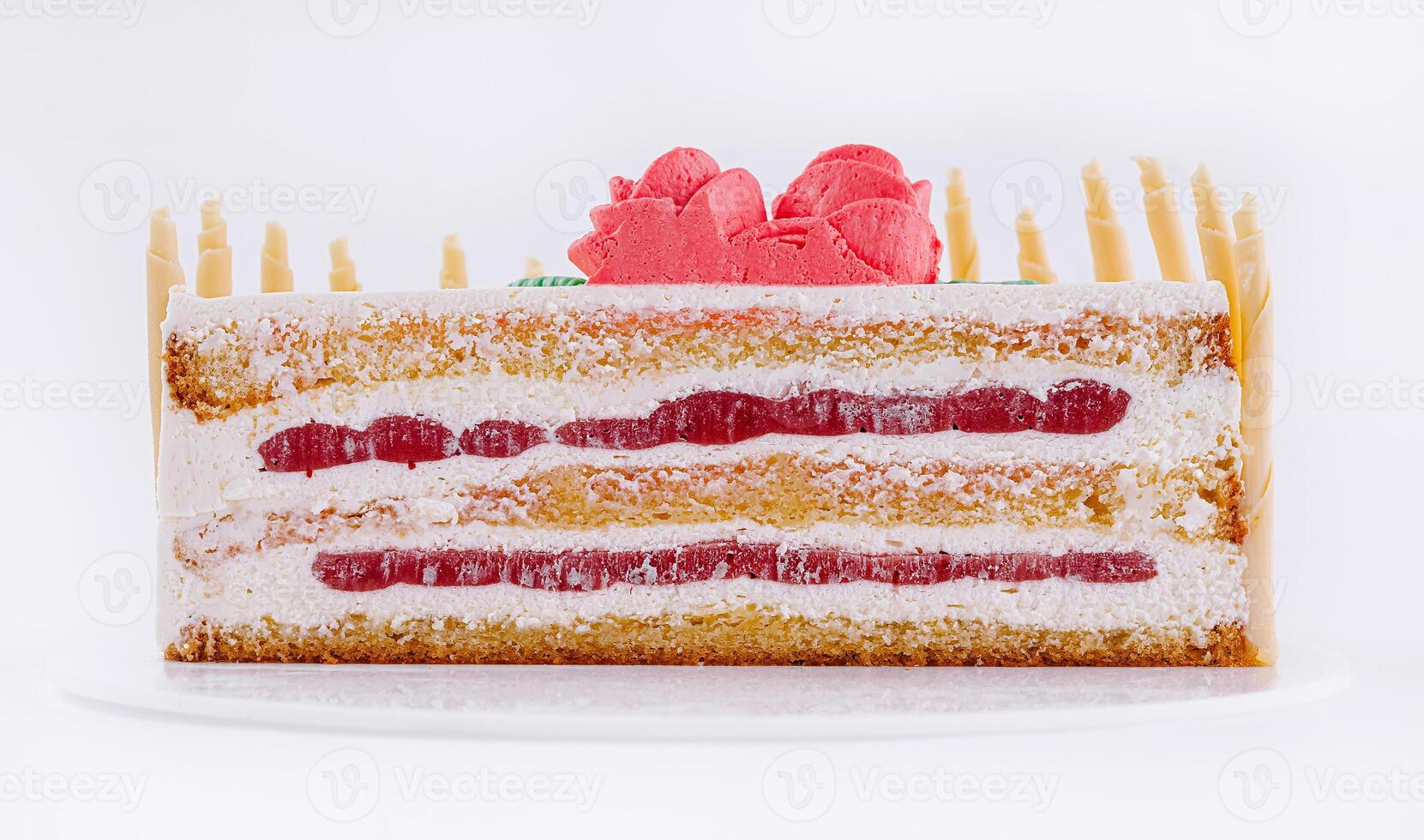 Delicious layered cake with cream and strawberry filling displayed on a white plate photo