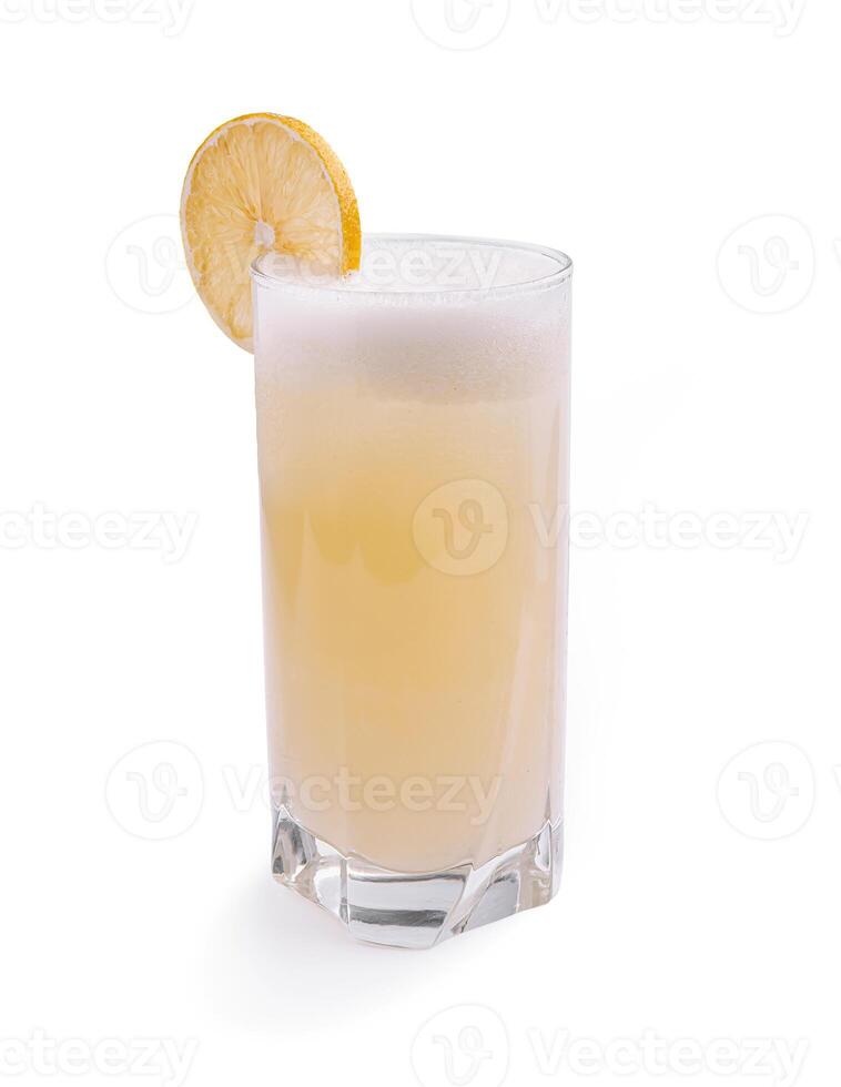 Refreshing lemon beverage in a tall glass garnished with a lemon slice and topped with frothy foam photo