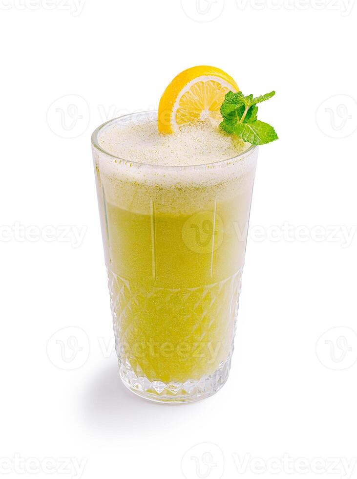 Refreshing citrus beverage with mint leaves served in a tall glass on a white background during the daytime photo