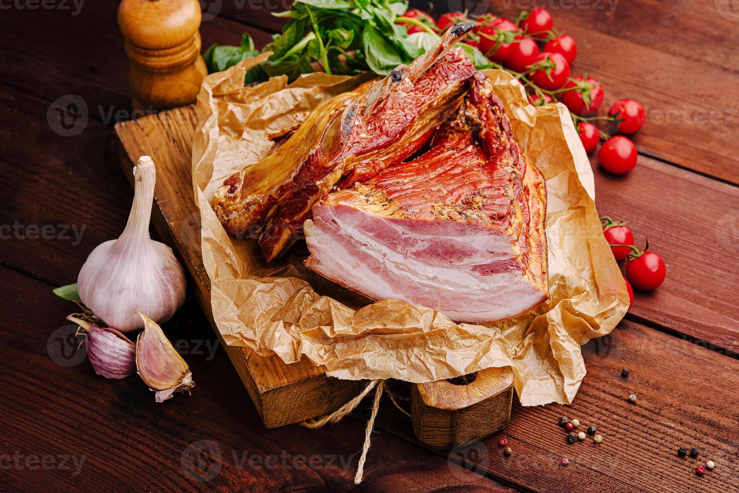 Freshly sliced meat with garlic and cherry tomatoes on a wooden table photo