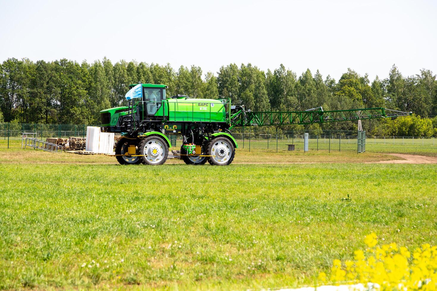 Republic of Tatarstan, Kazan - June 3, 2024. Agriculture tractor spraying fertilizer on green tea fields, Technology smart farm concept photo