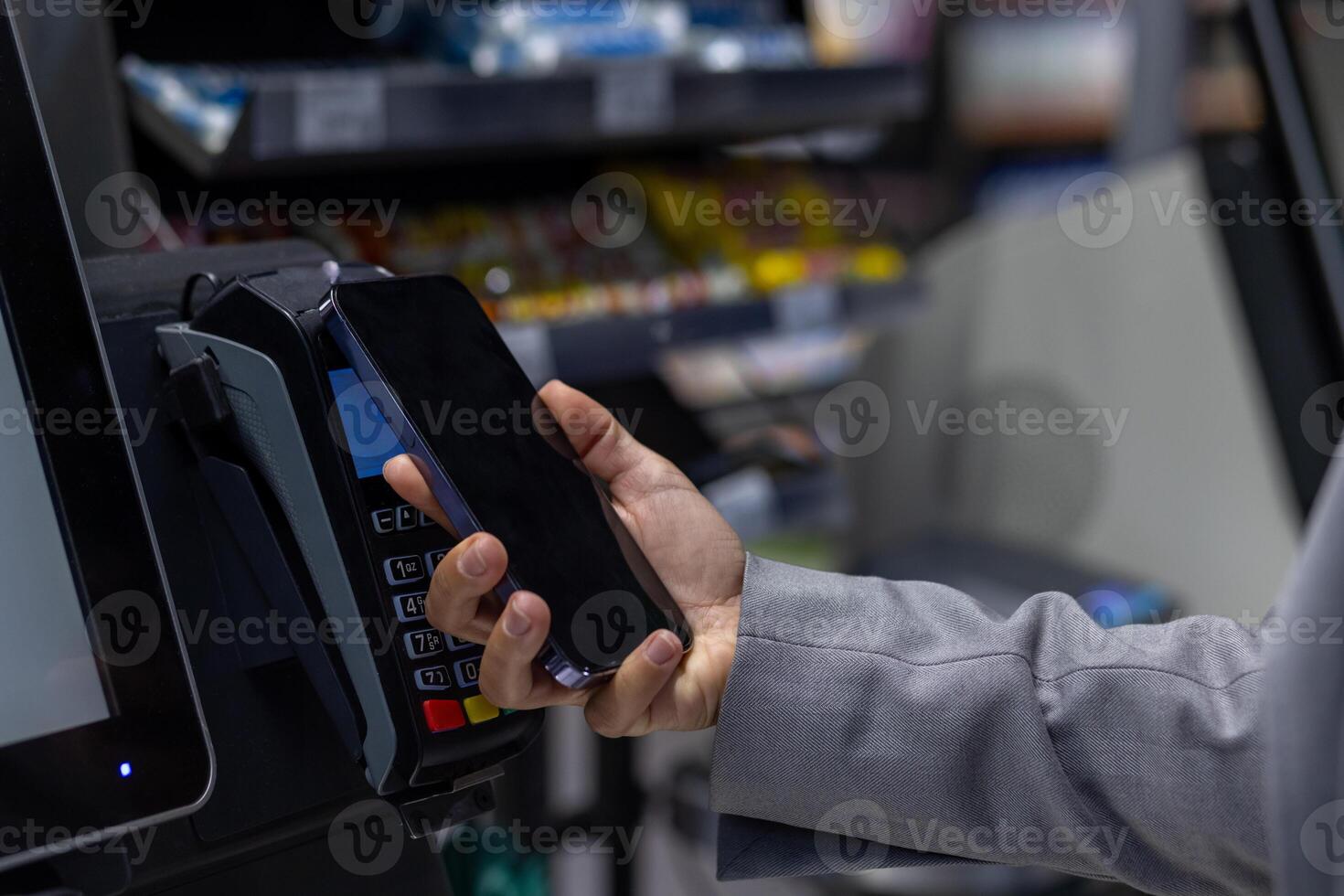 Close-up image showing contactless payment with smartphone. Person using digital wallet for transaction at retail store. Concept of cashless payments, convenience, and modern technology. photo