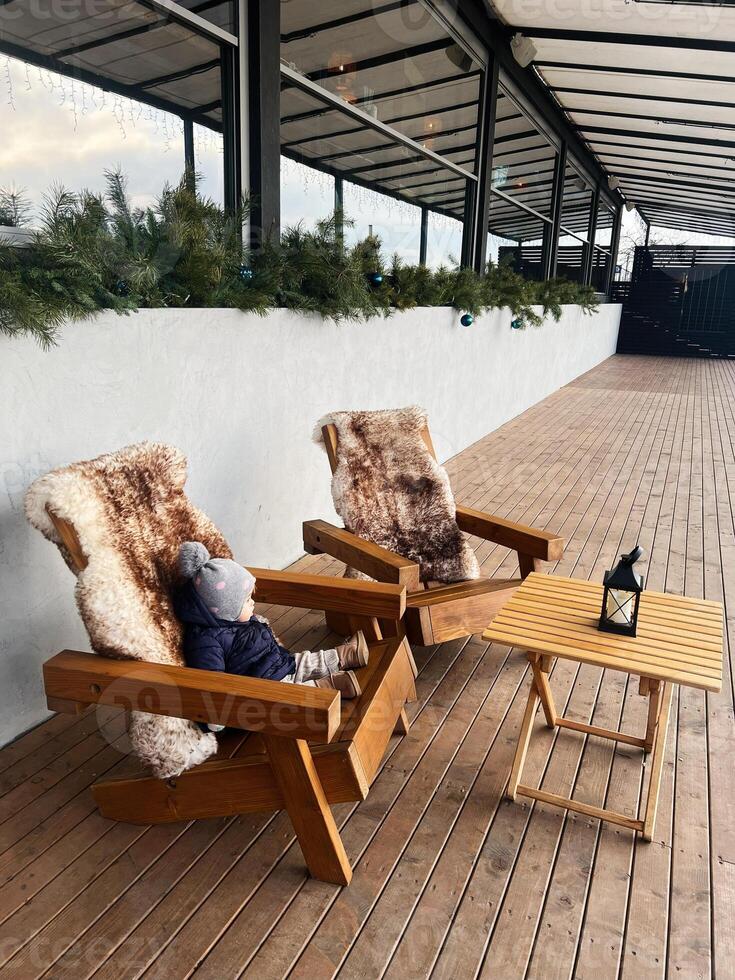 Cozy outdoor seating with wooden chairs and greenery decoration photo