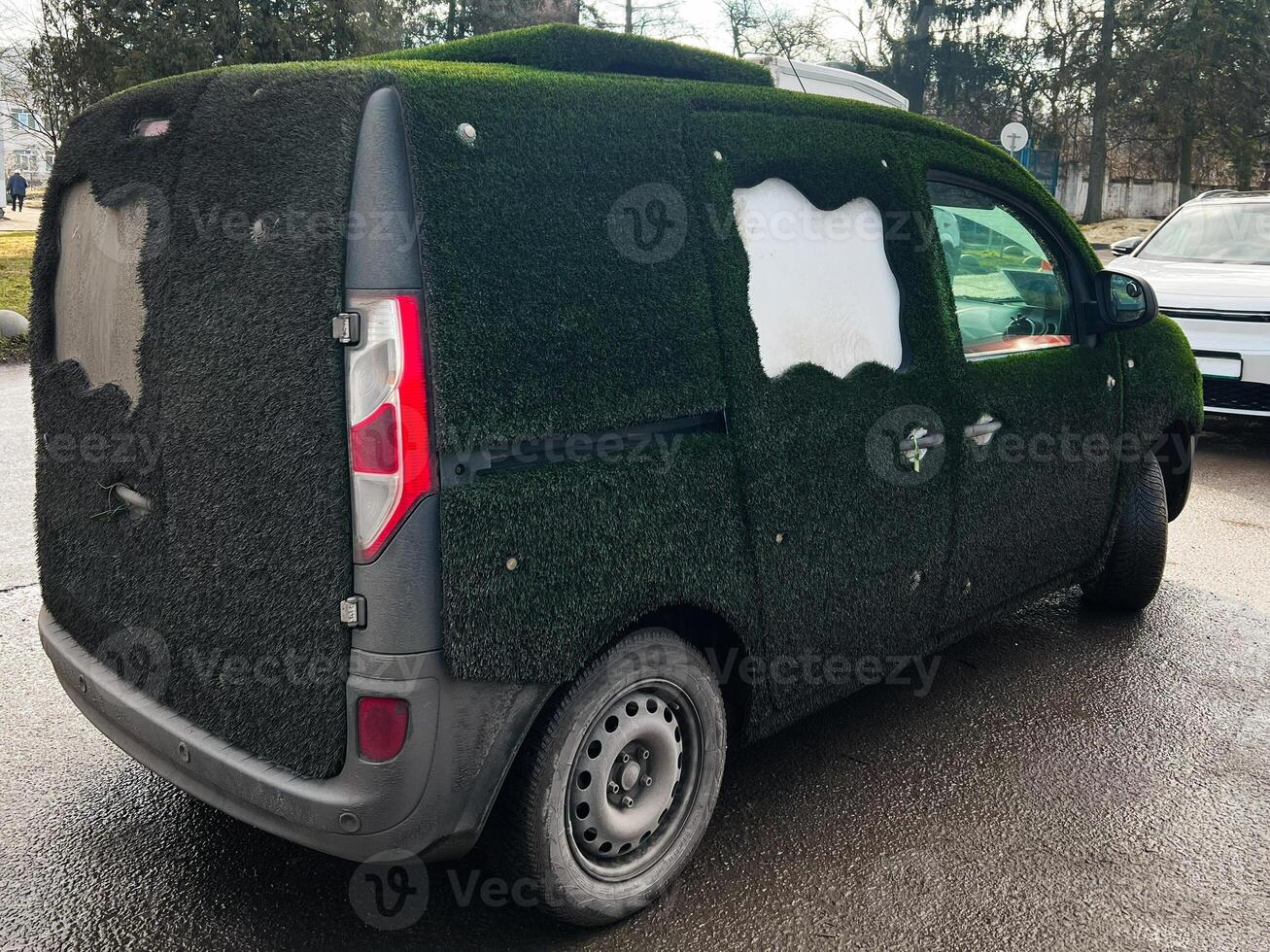 Unique van covered with artificial grass creating an eco-inspired custom design photo
