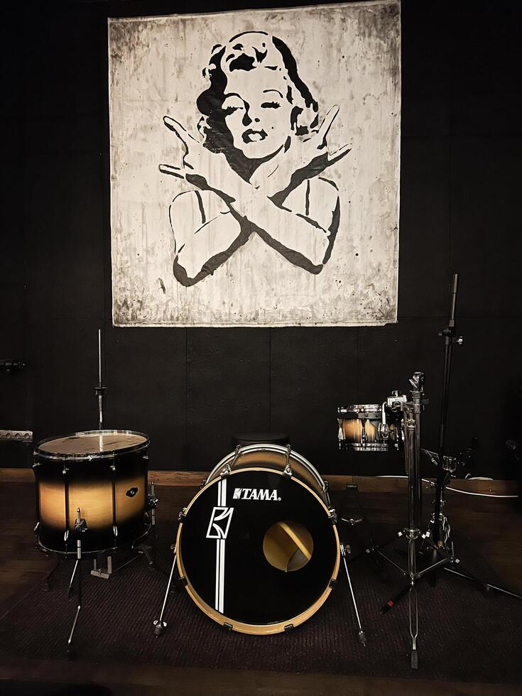 Kyiv, Ukraine - January 30, 2025 Tama Drum Kit in Studio With Artistic Portrait Background Wall Art Marilyn Monroe photo