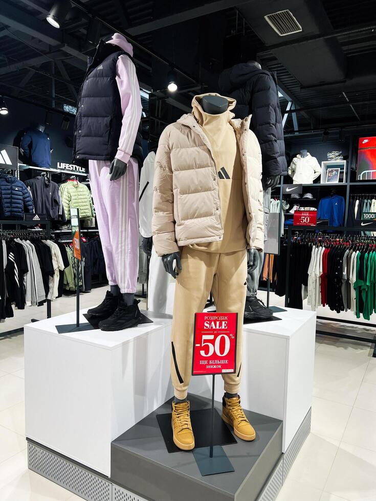 Kyiv, Ukraine - January 21, 2025 Apparel store mannequin display featuring winter sale promotion and stylish outfits photo